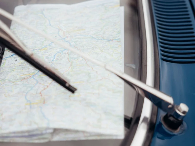 A vintage car dashboard with a map and windshield wipers, emphasizing classic automotive care.